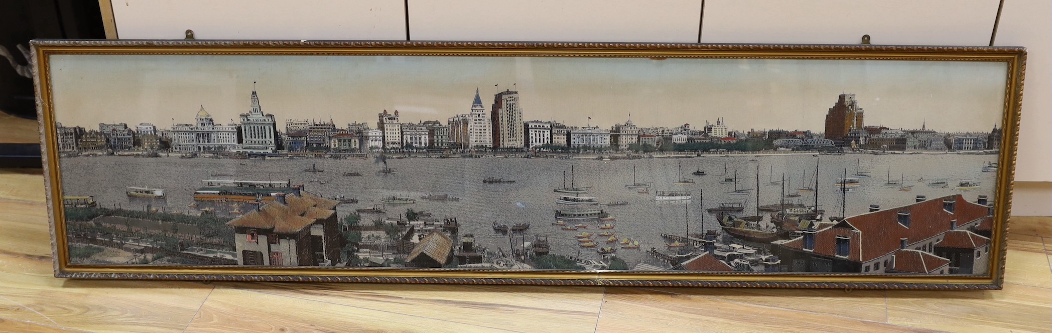 A framed early 20th century Chinese machine woven panorama of Shanghai harbour, 39x165cm excl frame